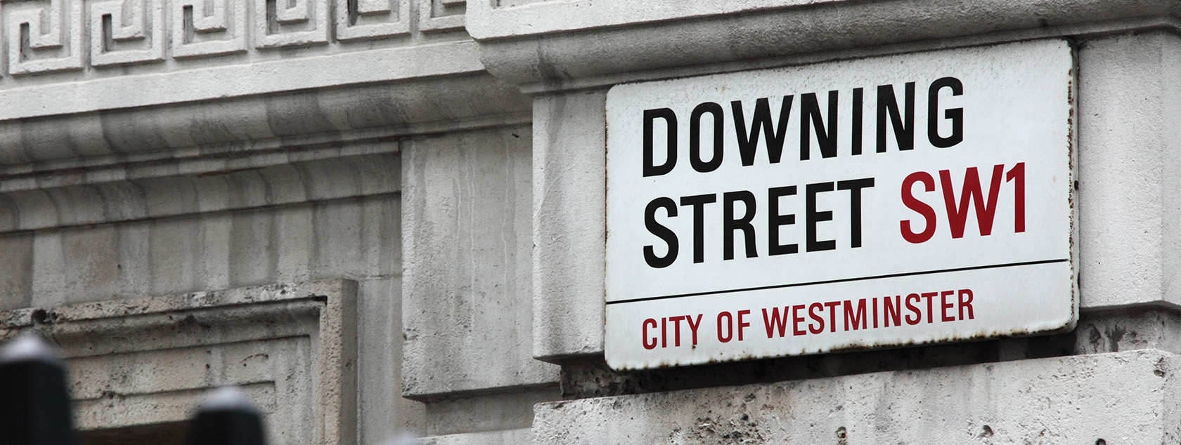 Downing Street sign on the side of building 